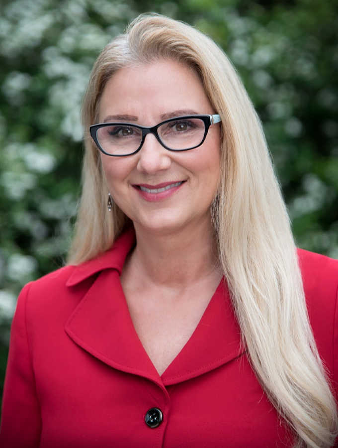 Woman in red jacket with glasses