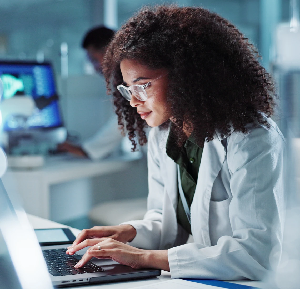 Woman typing in laboratory setting