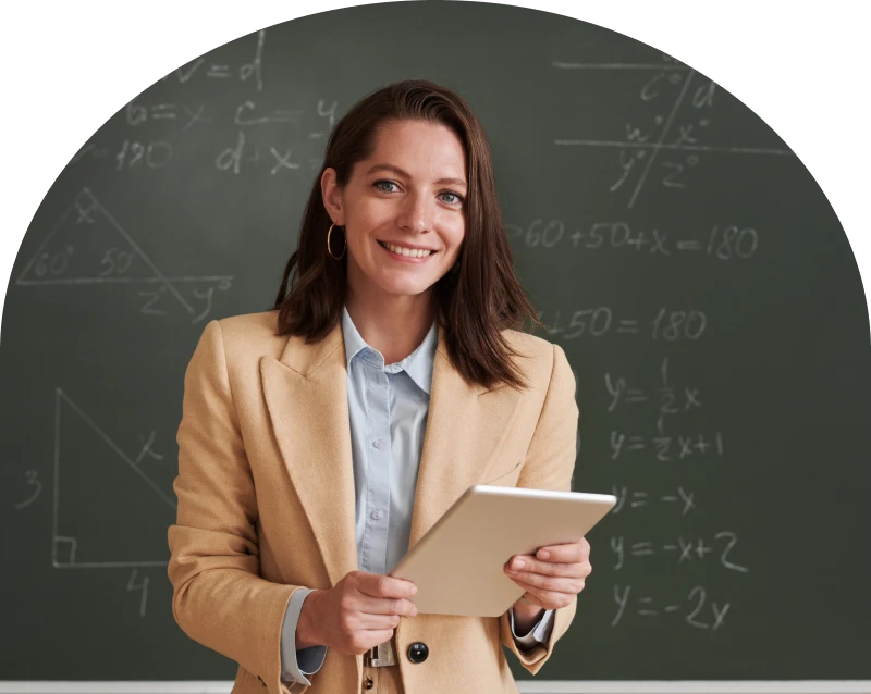 Woman smiling in front of chalkboard