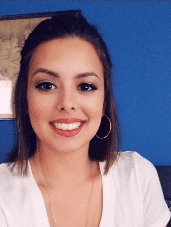 Woman in front of blue wall