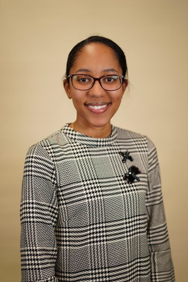 Smiling person in plaid dress