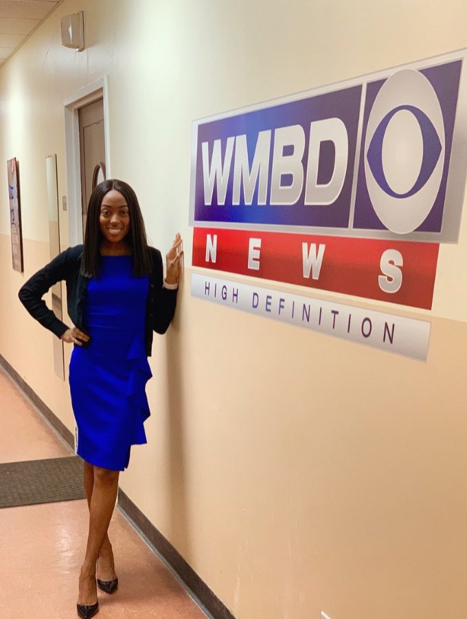 Person in blue dress by news logo